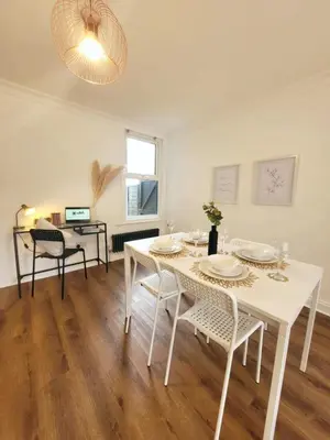 a white dining room with a white table and chairs at 3-Bed, Sleeps 6, 1 Bath, Parking, WiFi in Halstead