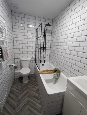 a white bathroom with a toilet and a bath tub at 3-Bed, Sleeps 6, 1 Bath, Parking, WiFi in Halstead