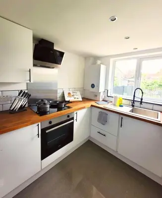 a kitchen with white cabinets and a sink at 3-Bed, Sleeps 6, 1 Bath, Parking, WiFi in Halstead