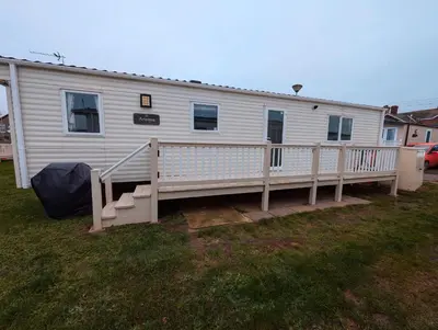 a mobile home with a porch and a deck at Van-Tastic 6 berth static in Felixstowe