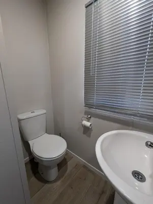 a bathroom with a toilet and a sink at Van-Tastic 6 berth static in Felixstowe