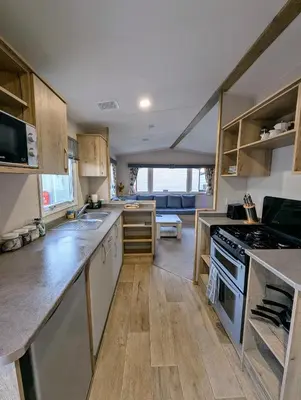 a kitchen with a sink and a stove top oven at Van-Tastic 6 berth static in Felixstowe
