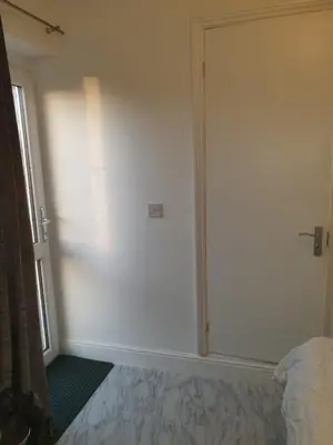 a bedroom with a sliding glass door and a bed at Room Stay - Marks tey, Colchester, United Kingdom in Marks Tey