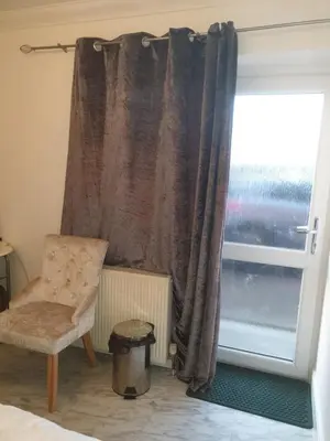 a bedroom with a chair and a window at Room Stay - Marks tey, Colchester, United Kingdom in Marks Tey