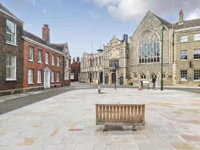 a bench sitting in the middle of a courtyard at Dovecote Cottage in Downham Market