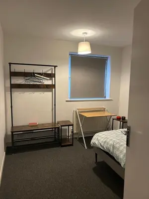 a room with a bedroom with a bed and a window at Newmarket house in Newmarket
