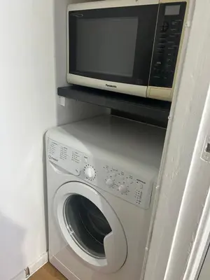 a microwave sitting on top of a washing machine at Newmarket house in Newmarket
