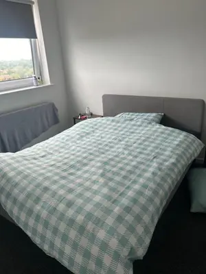 a bed in a bedroom with a checkered blanket at Newmarket house in Newmarket