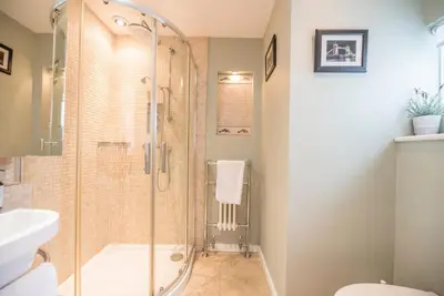 a bathroom with a shower and a sink at Oriel Cottage, Aldeburgh in Aldeburgh