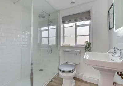 a bathroom with a toilet and a sink and a shower at The Keep - Framlingham in Framlingham