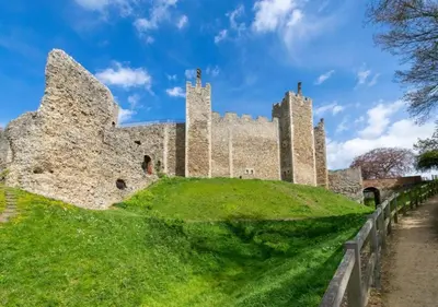 a castle on top of a green hill at The Keep - Framlingham in Framlingham
