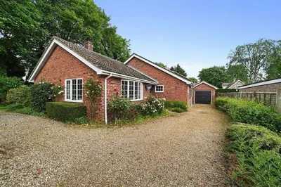 a brick house with a garage and a driveway at 10 Holly Close in Westley