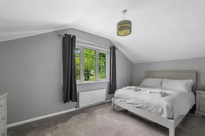 a bedroom with a bed and a window at 10 Holly Close in Westley