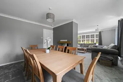 a living room with a wooden table and chairs at 10 Holly Close in Westley