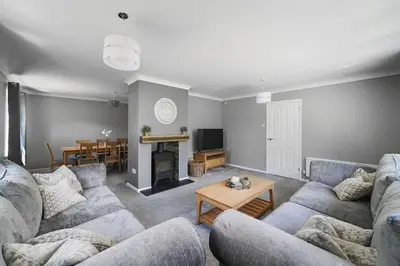 a living room with two couches and a table at 10 Holly Close in Westley