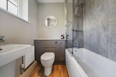 a bathroom with a toilet and a tub and a sink at 10 Holly Close in Westley