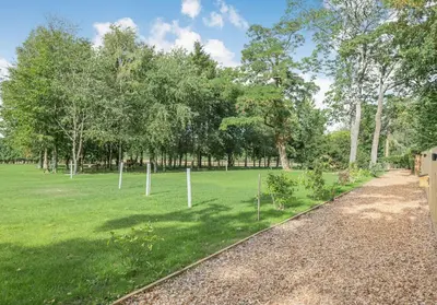 a park with trees and a grass field at Luxury Chestnut Lodge with Hot Tub and Games Room in Toppesfield