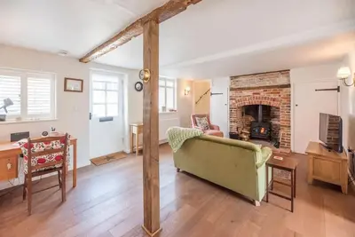 a living room with a couch and a fireplace at 10 Angel Lane, Woodbridge in Woodbridge