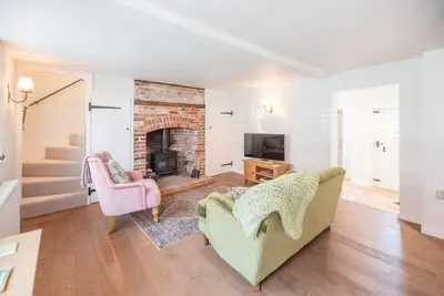 a living room with a couch and a fireplace at 10 Angel Lane, Woodbridge in Woodbridge