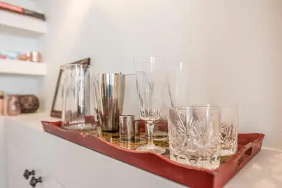 a tray filled with glasses sitting on a counter at 10 Angel Lane, Woodbridge in Woodbridge