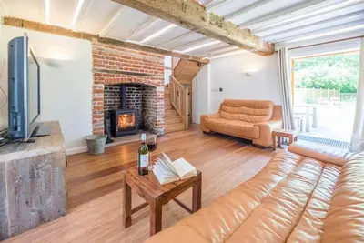 a living room with a couch and a fireplace at Little Swattesfield, Eye in Eye