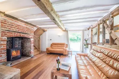 a living room with a couch and a fireplace at Little Swattesfield, Eye in Eye