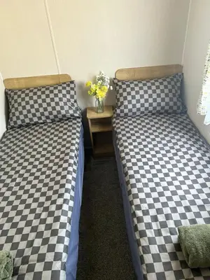 two beds sitting next to each other in a room at Highfield Grange Holiday Park in Clacton-on-Sea