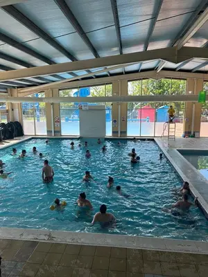 a group of people swimming in a swimming pool at Highfield Grange Holiday Park in Clacton-on-Sea