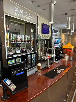 a bar at a bar with a phone on the counter at Highfield Grange Holiday Park in Clacton-on-Sea