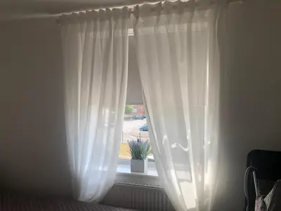 a window with white curtains in a bedroom at Basildon, private room in a flat in Basildon