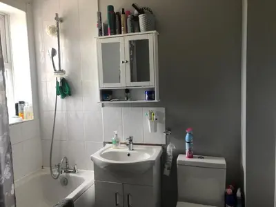 a bathroom with a sink and a toilet and a mirror at Basildon, private room in a flat in Basildon