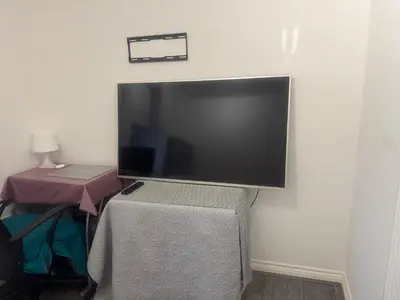 a large flat screen tv hanging on a wall at Basildon, private room in a flat in Basildon
