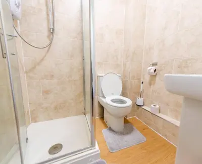 a bathroom with a shower with a toilet and a sink at Cozy 4-guest Getaway In The Heart Of Ipswich in Ipswich