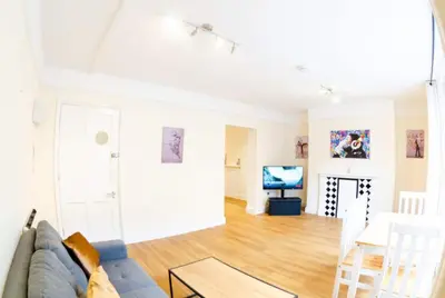 a living room with a couch and a table at Cozy 4-guest Getaway In The Heart Of Ipswich in Ipswich