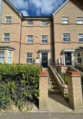 a large brick building with stairs in front of it at Stunning Beachfront House in Felixstowe