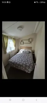 a bedroom with a large bed in a room at 8 berth caravan Martello Beach Clacton in Jaywick Sands