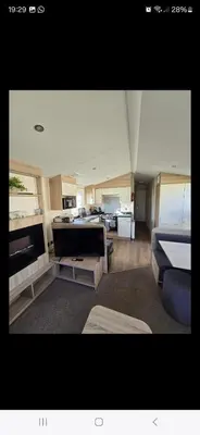 a large living room with a bed and a couch at 8 berth caravan Martello Beach Clacton in Jaywick Sands
