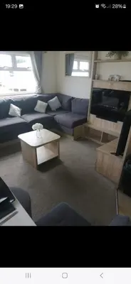 a living room with a couch and a coffee table at 8 berth caravan Martello Beach Clacton in Jaywick Sands
