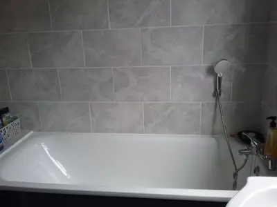 a bath tub in a bathroom with a shower at medium sized room in my bungalow in Great Clacton