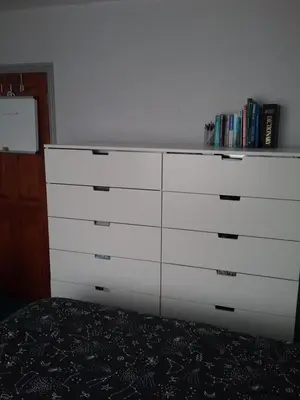 a white dresser in a room with a bed at medium sized room in my bungalow in Great Clacton