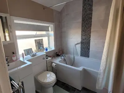 a bathroom with a white tub and a toilet at Felixstowe room lets in Felixstowe