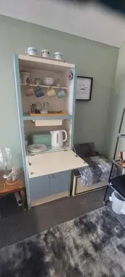 a room with a shelf with dishes on it at Felixstowe room lets in Felixstowe