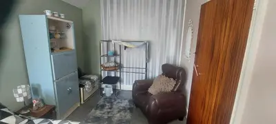 a living room with a chair and a shelf at Felixstowe room lets in Felixstowe