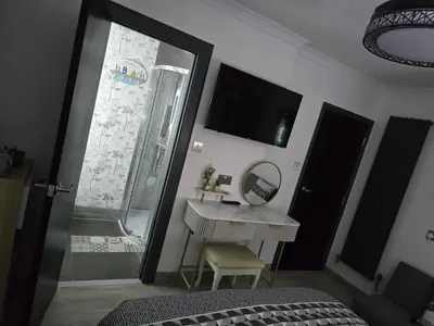 a bedroom with a bed and a desk and a mirror at Martello Bay Hotel in Clacton-on-Sea