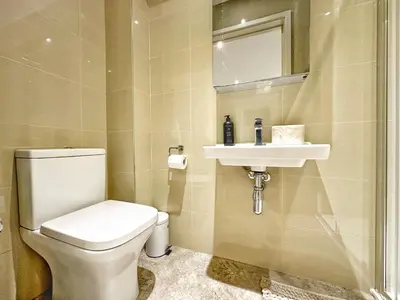 a bathroom with a toilet and a sink at Gwydir Street Stays in Cambridge