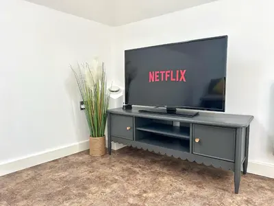 a flat screen tv on a black entertainment center at Gwydir Street Stays in Cambridge