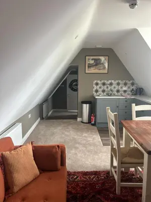 a living room with a couch and a table at Trowel and Hammer Flat 1 in Cotton