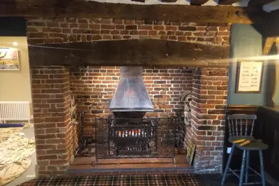 a brick fireplace with a bell in it at Trowel and Hammer Flat 1 in Cotton