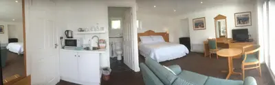 a hotel room with a bed and a living room at Annexe at Gosfield Lake in Gosfield