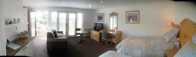 a bedroom with a bed and a desk and a chair at Annexe at Gosfield Lake in Gosfield
